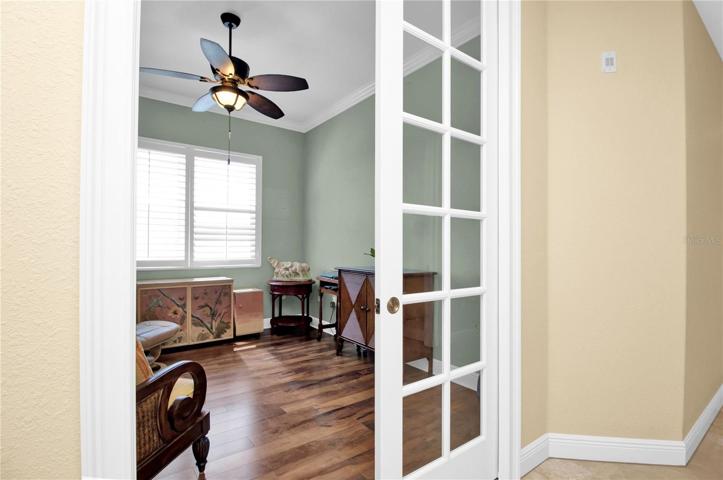 Pocketed French window-pane doors welcome you to the current den/study