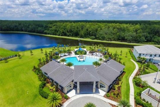 Community pool aerial view with lake view 