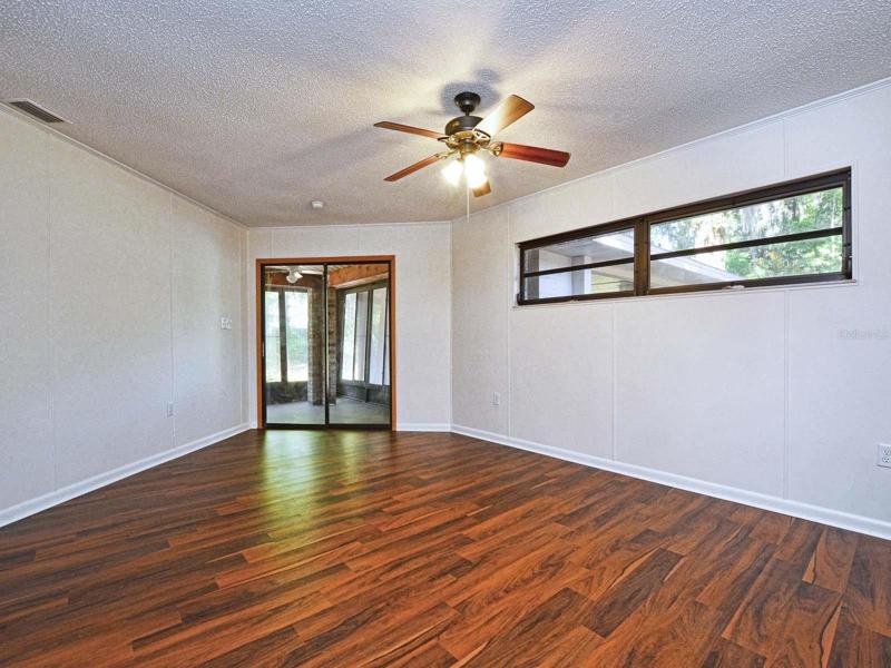 Bedroom view toward sliding door to screened porch