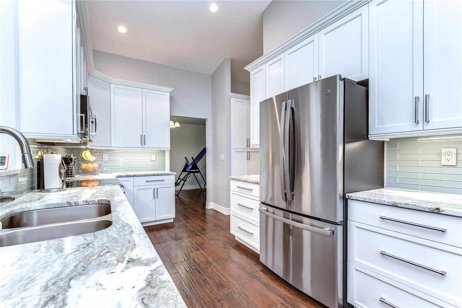 Featuring 42-inch white wood cabinets with crown, subway tile backsplash and stunning granite countertops!