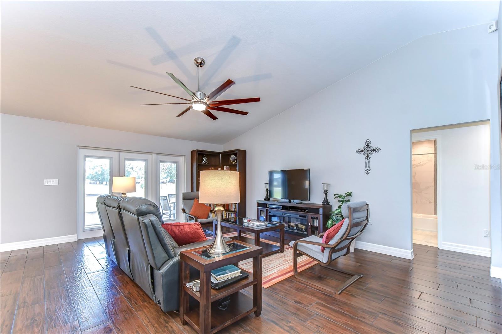 Great room features French doors that lead out to the lanai and vaulted ceilings for ample light to flow through effortlessly!