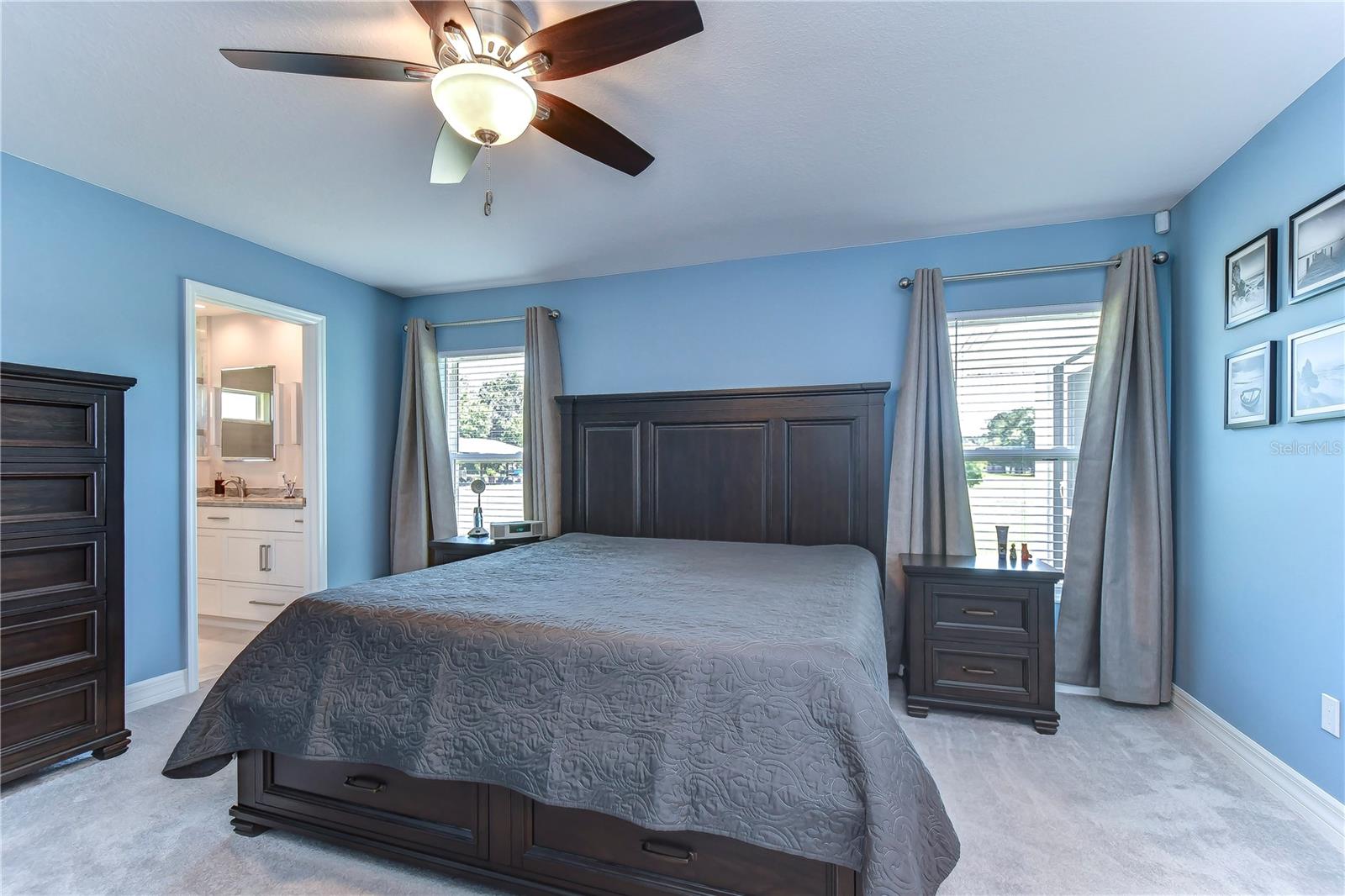 Two large windows in primary bedroom allow ample light to stream in and create a warm ambiance!