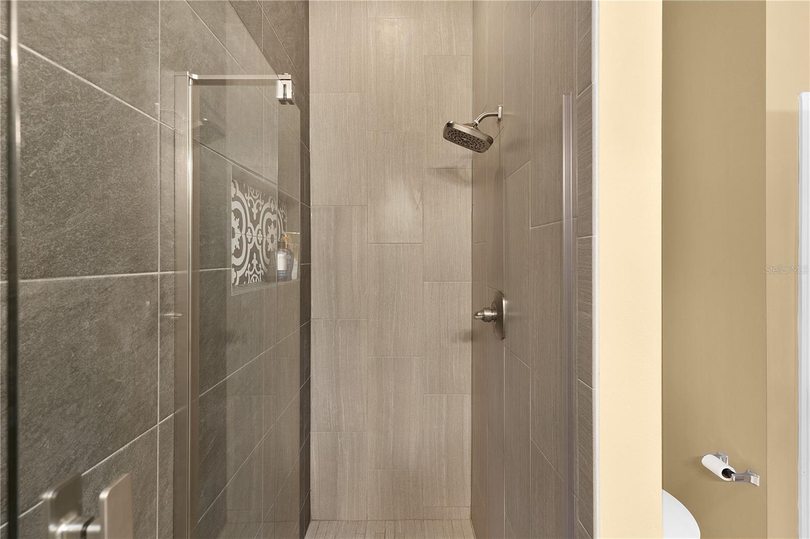 CUSTOM TILE WALK IN SHOWER, FRAMELESS GLASS DOOR.