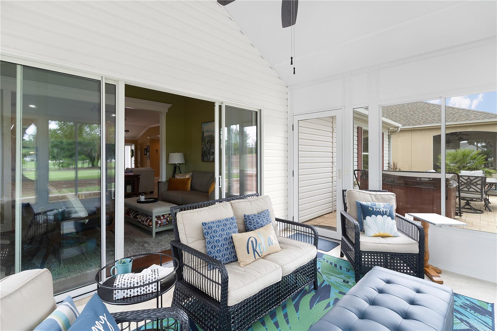 SLIDER FROM FLORIDA ROOM TO LANAI. HOT TUB OUT ON THE BRICK PAVER PATIO WILL CONVEY.