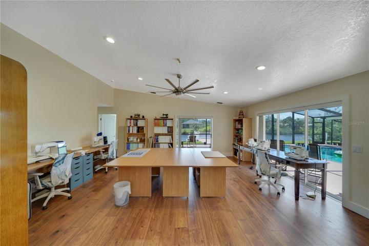 Large family room enjoys access to the pool/lanai thru a wall of sliding glass doors and also a second sliding glass doors that lead to a covered area on the lanai