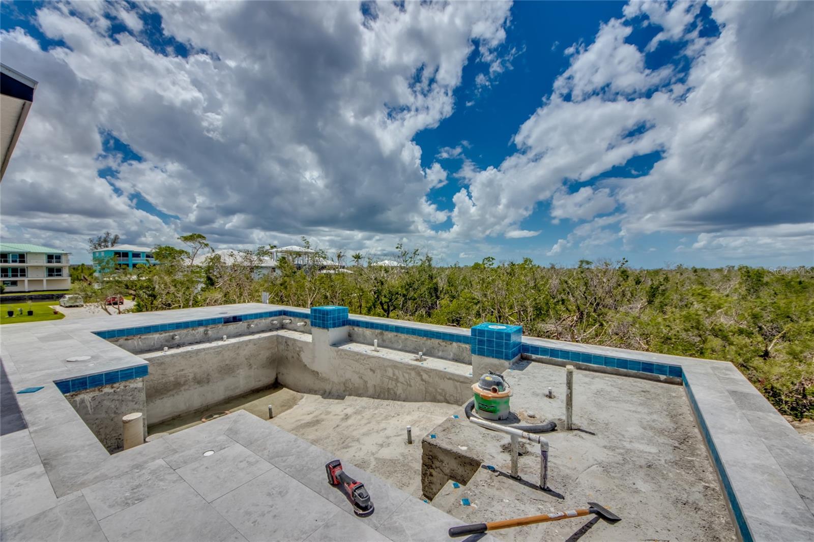 This photo shows the resort style pool but you would have to see it in person to appreciate it!  Bench seating, bar seating, spa therapy jets, multiple play areas and ledges - truly a work of art and designed to be used every day!
