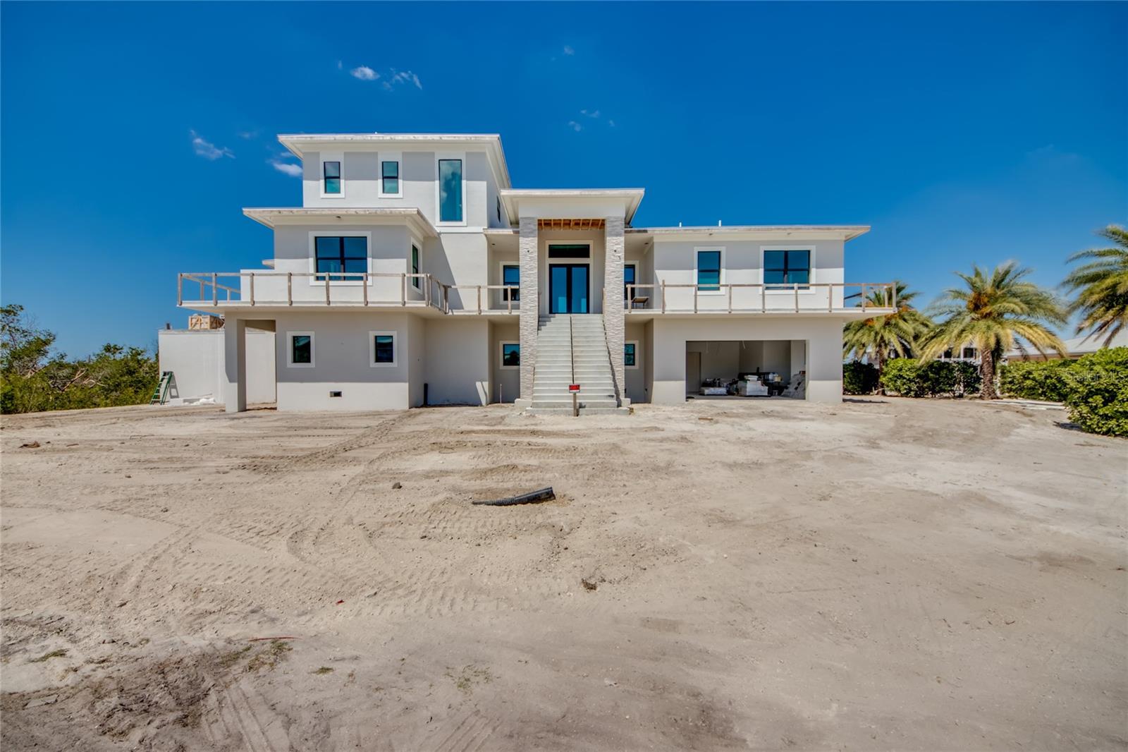 Front view of this amazing home - whole house generator, 1,000 gallon gas, extended garage, precast stairs, wrap around balcony on second floor and so much more!