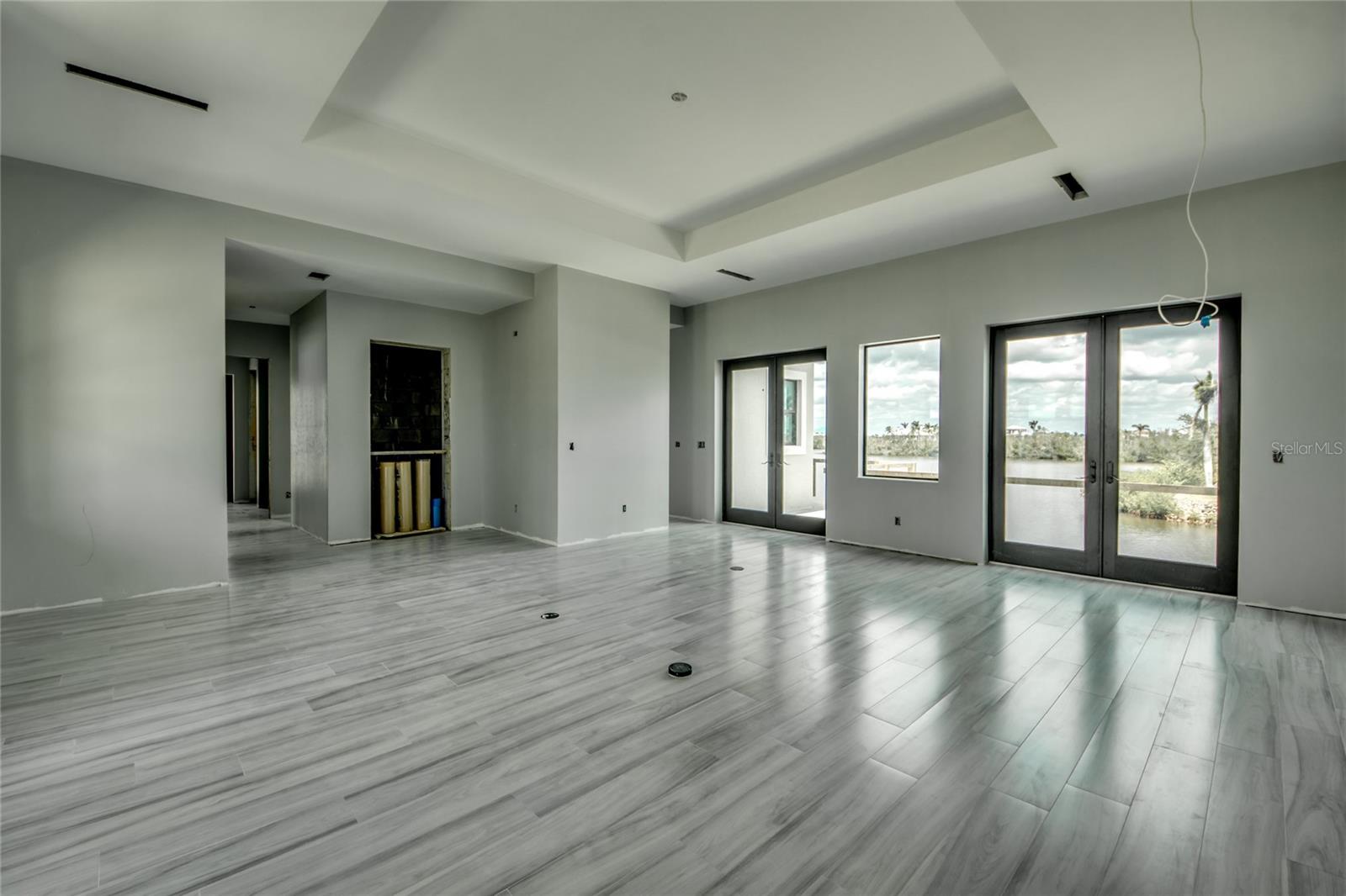 Step right off the elevator into your beautiful 22 x 22 living room with double french doors to the outside wrap around balcony and pool area.  All ceramic plank tiling - a neutral palette that flows throughout the home.  Tray ceiling - a sophisticated yet simple design that exudes serenity and laid back living!