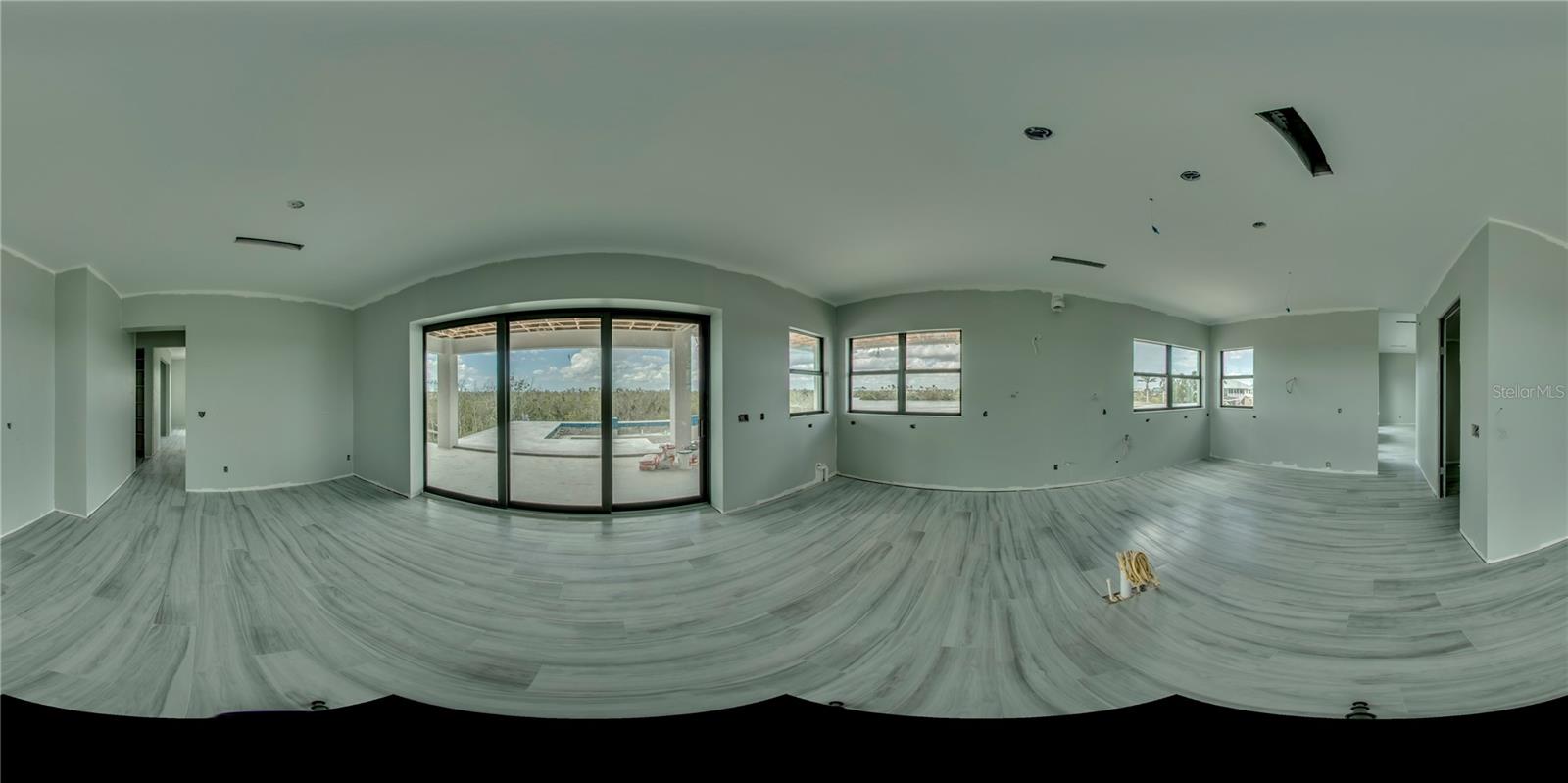 Panoramic view of the kitchen and dining area.  Kitchen is super custom with high end appliances, huge walk in pantry, wine fridge and large kitchen island 