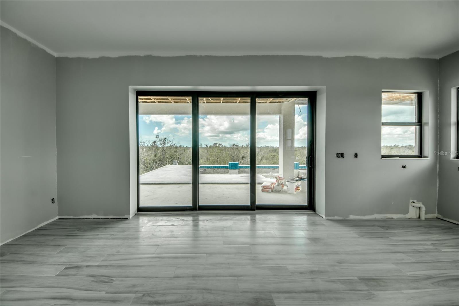 Dining area off kitchen - straight view and access out to the pool and main entertainment areas.