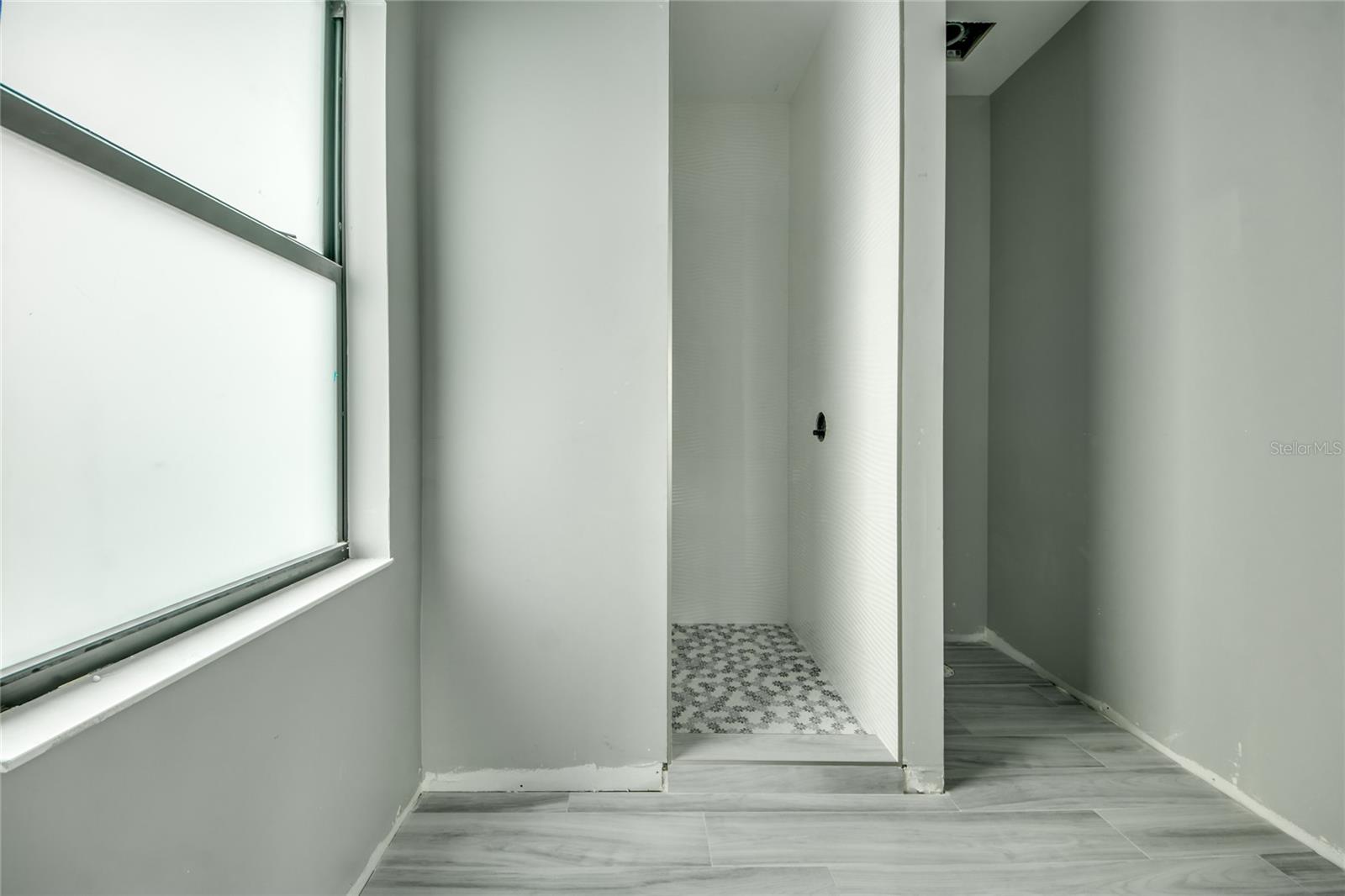 Attached guest  bathroom - total of two junior en-suites along with a third guest bedroom on the main living area.  Each bathroom is designed with different tile and trim and adds to the beauty of this home.