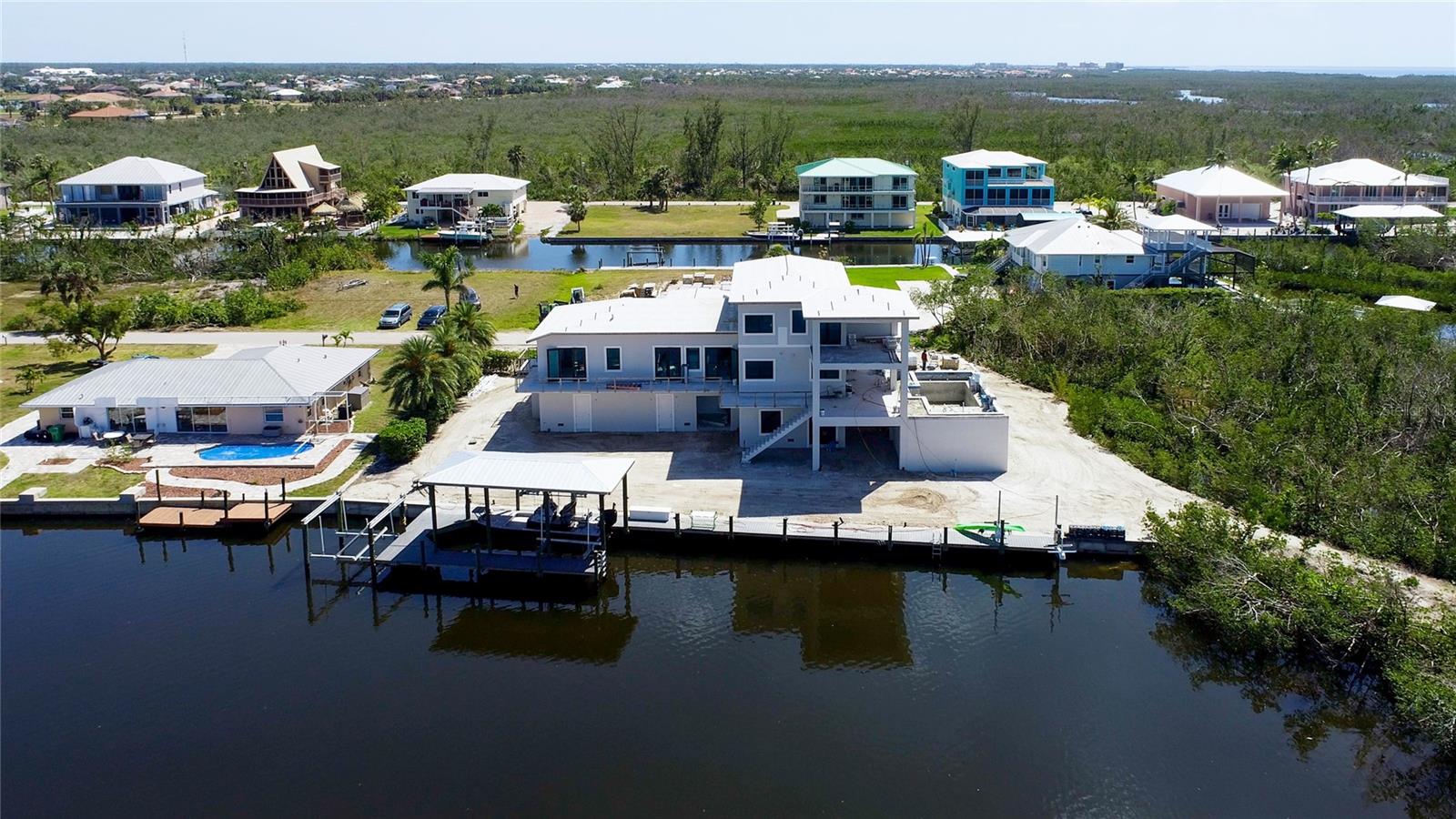 View from the water looking at the rear of the property!  An estate home built like a fortress in pure paradise!
