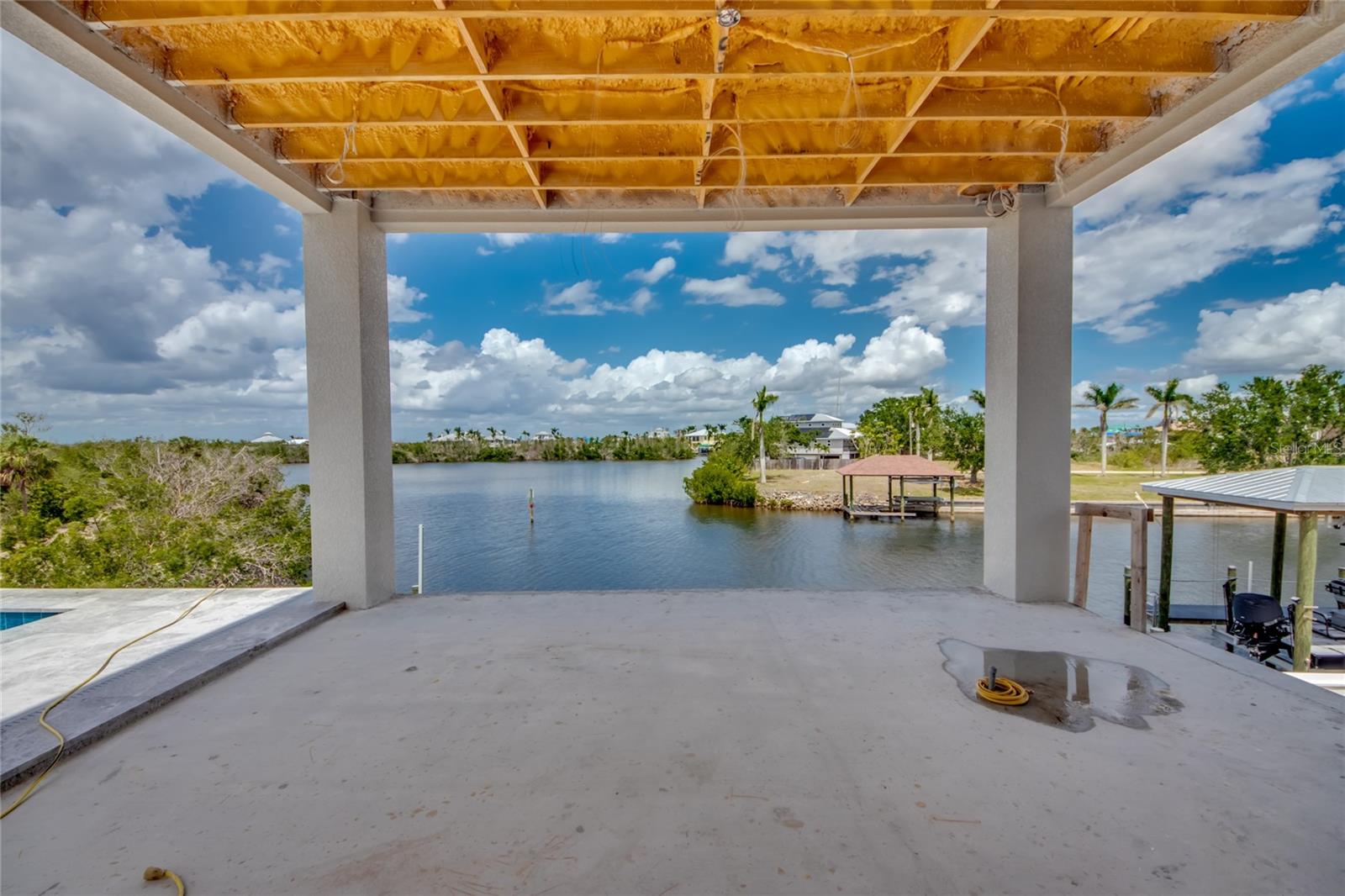 One of two sister size outdoor balconies - this one is located on the main living area and is only one small part of an amazing outdoor pool/entertainment area.  Cypress beams, a pool cage and electric hurricane shutters will complete the look along with an incredible outdoor kitchen setup!
