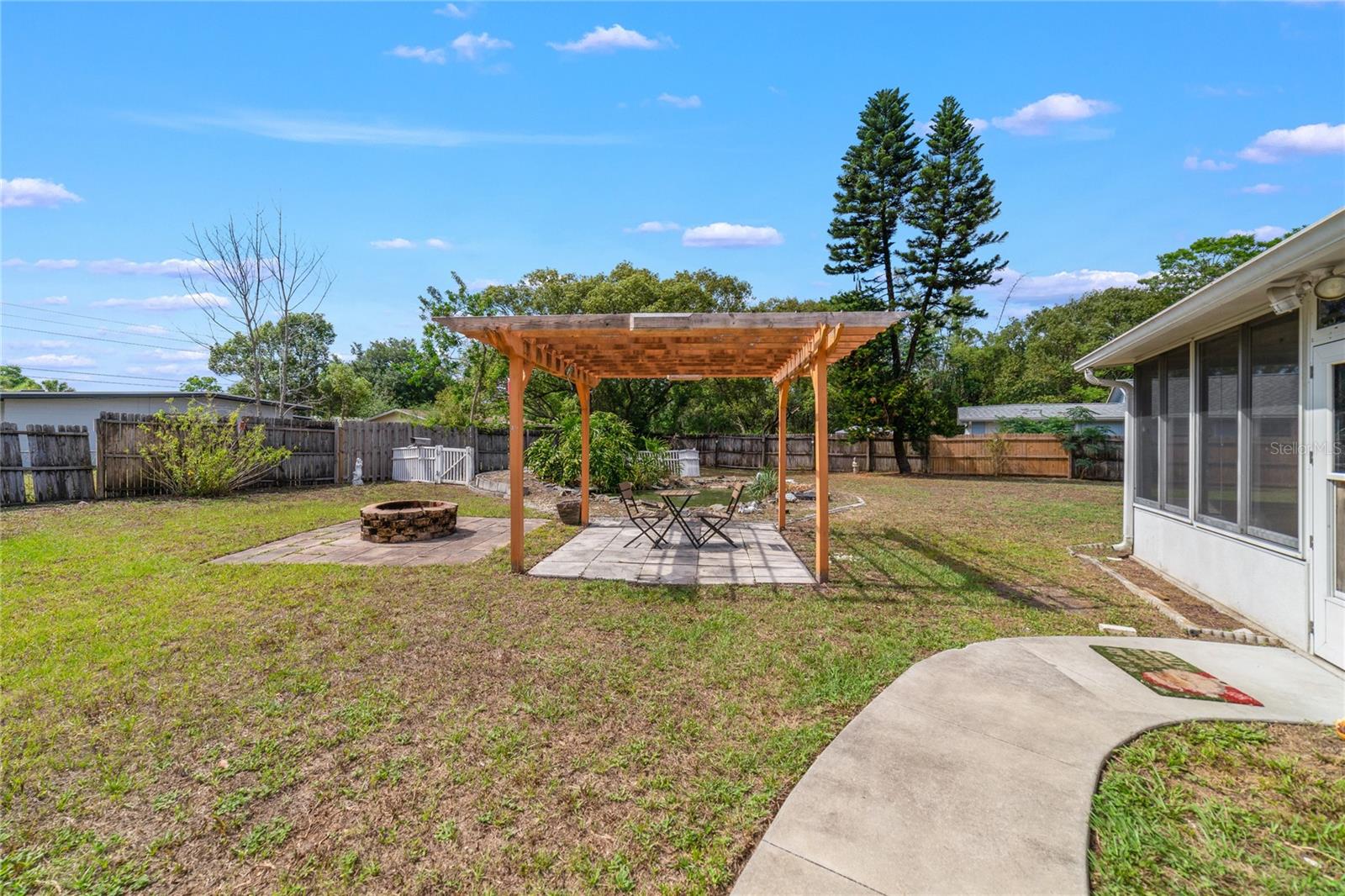 This sprawling property is FULLY FENCED and includes multiple structures including COVERED RV/BOAT PARKING, a fun GAZEBO to enjoy the FIRE PIT and all with NO HOA!