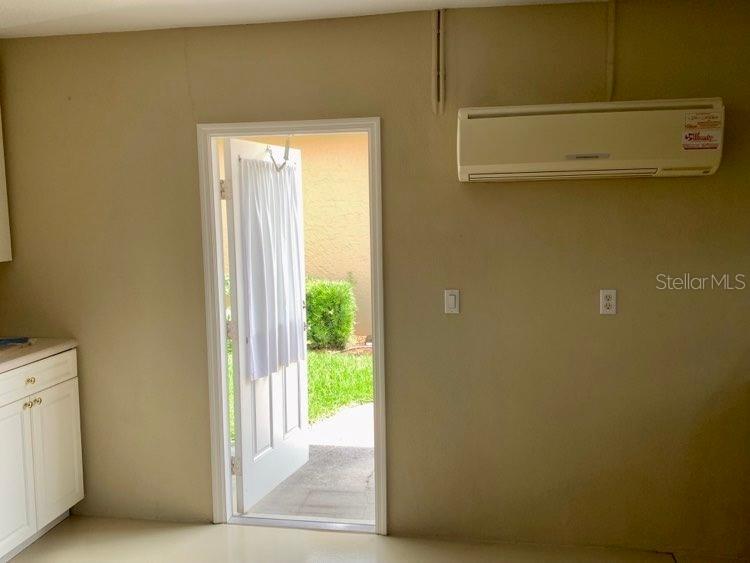 Featured home is at left side of photo with lanai lights on