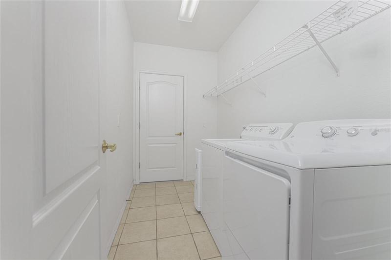 Large laundry room with wire shelves 