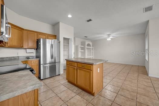 KITCHEN with FAMILY ROOM TO THE REAR