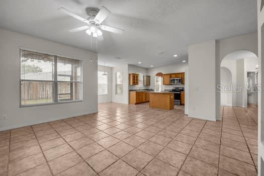 VIEW FROM LARGE ROOM TOWARD KITCHEN AND FOYER AREA