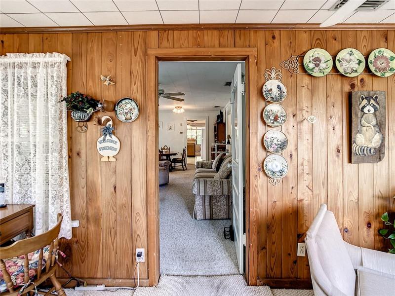 The den opens up to the formal living room and dining room.