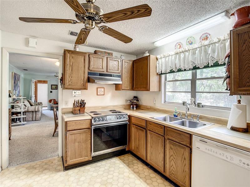 The kitchen has wood cabinets and plenty of work space.