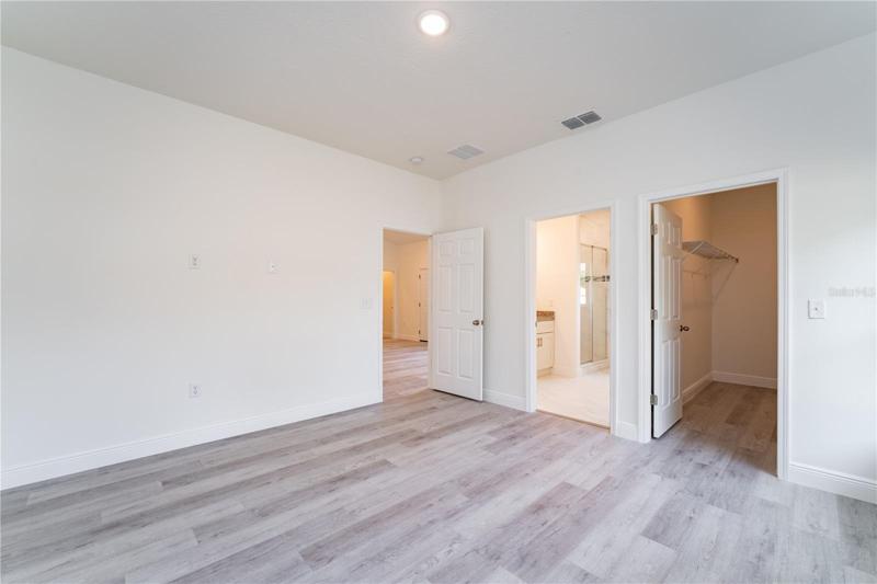 Large walk-in closet in the primary bedroom. This is a model; the actual colors, finishes, and orientation may be different.