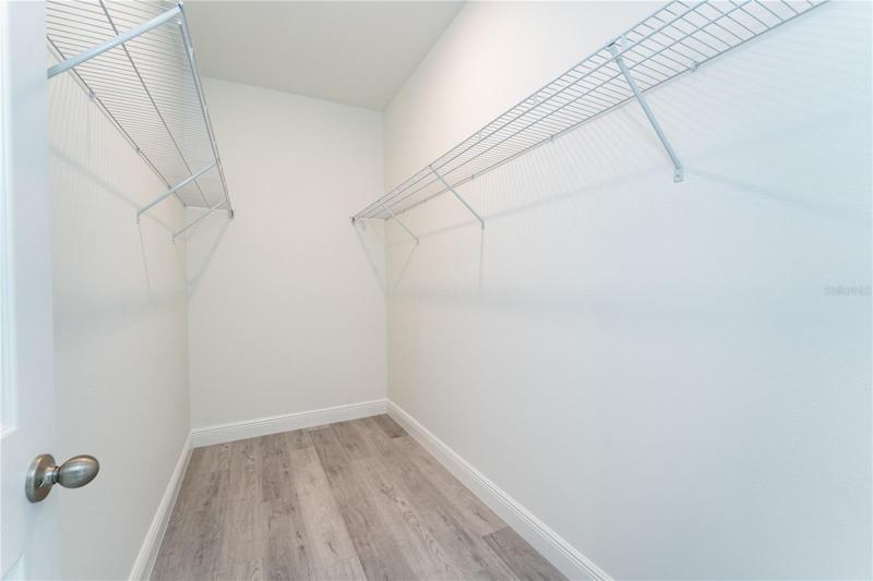 Large walk-in closet in the primary bedroom. This is a model; the actual colors, finishes, and orientation may be different.