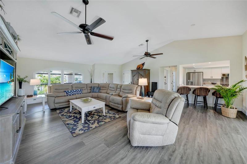 living room flows easily into the lanai or kitchen area with a breakfast bar that seats 3