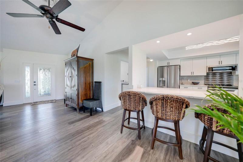 Plenty of natural light flows through this space with help from the light-colored luxury vinyl plank flooring and high ceilings. 