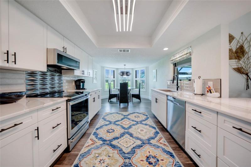 dinette area provides a more cozy and formal setting for larger parties and is nestled against a bay of windows overlooking the golf course