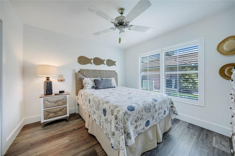guest bedroom 2 is a light and bright room with two windows bringing in so much natural light.  Plantation style windows are a wonderful addition to this space