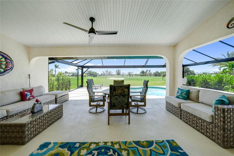 covered lanai area with long views of the golf course.  This is the view from the living room sliders