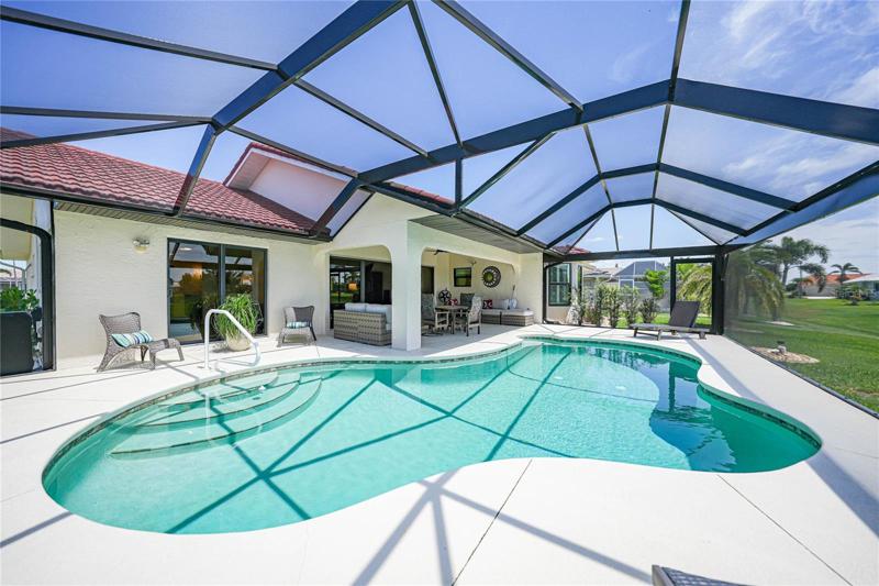 beautiful heated pool has a seating area to sit in the water and relax and enjoy the views