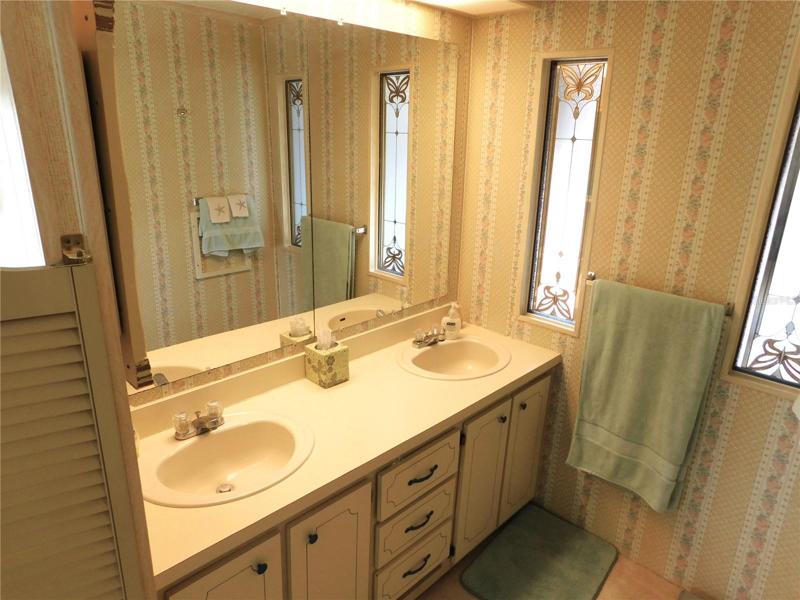 Maste bathroom has double sink and step-in shower.