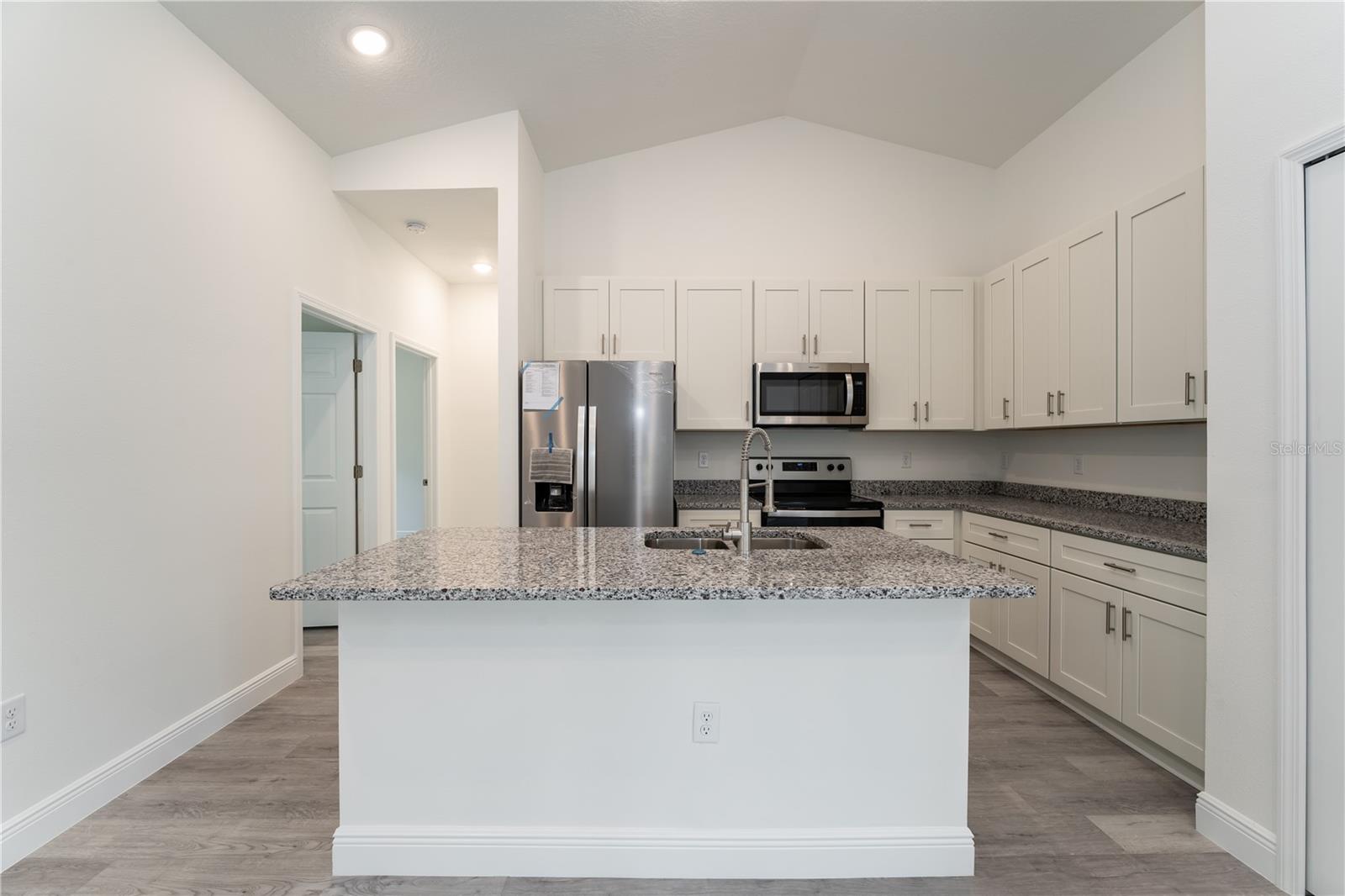 Stainless steel appliances, Soft-close 42"cabinets, granite countertops. This is a model; the actual colors, finishes, and orientation may be different.