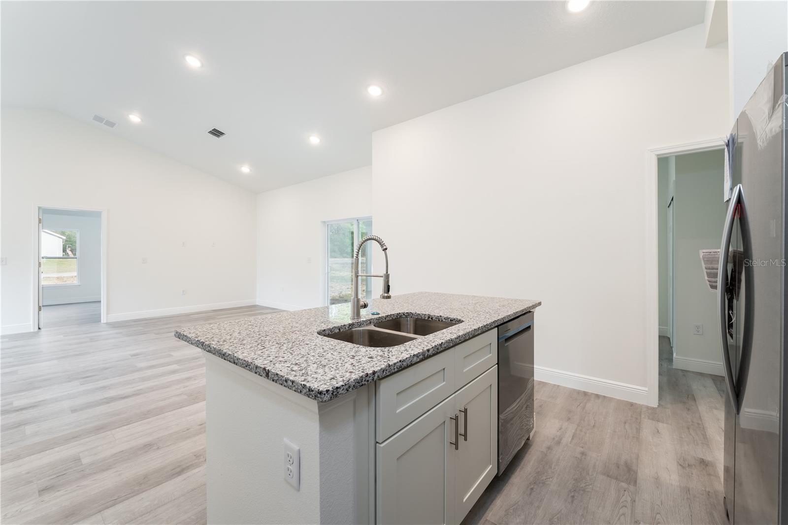 Stainless steel appliances, Soft-close 42"cabinets, granite countertops. This is a model; the actual colors, finishes, and orientation may be different.