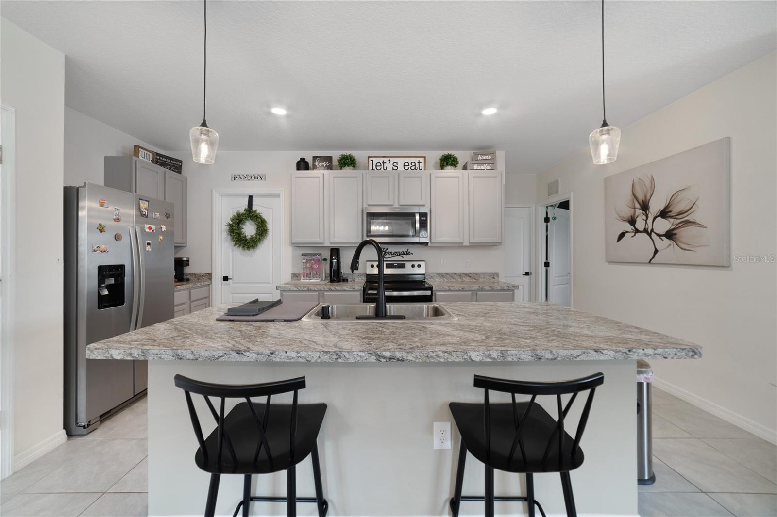 The home chef will appreciate being surrounded by everything the modern kitchen has to offer; GRANITE COUNTERS, STAINLESS STEEL APPLIANCES, WALK-IN PANTRY for plenty of storage and an ISLAND with additional seating at the breakfast bar! 