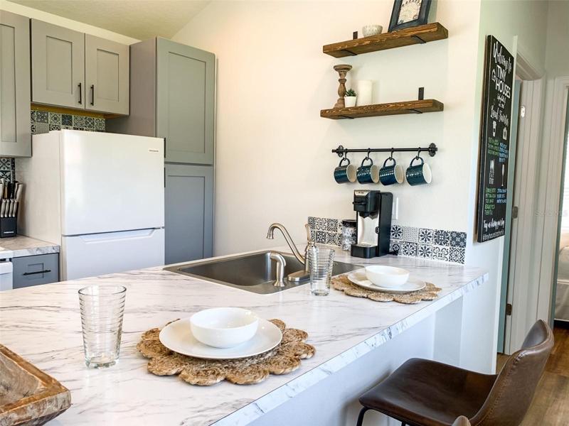Kitchen features Quartz Countertop Option, Stainless Steal Sink, Electric Range & Optional Dishwasher