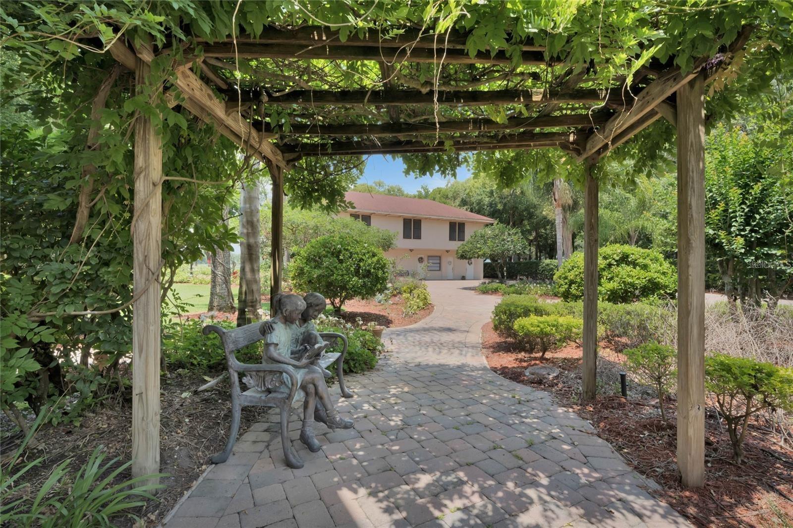 main house walkway to guest house and lake