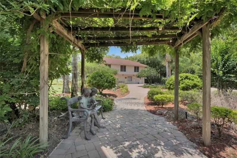 main house walkway to guest house and lake