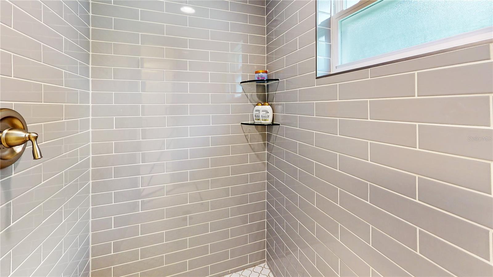 Glass tile shower in Master bathroom. Tile goes to the ceiling 