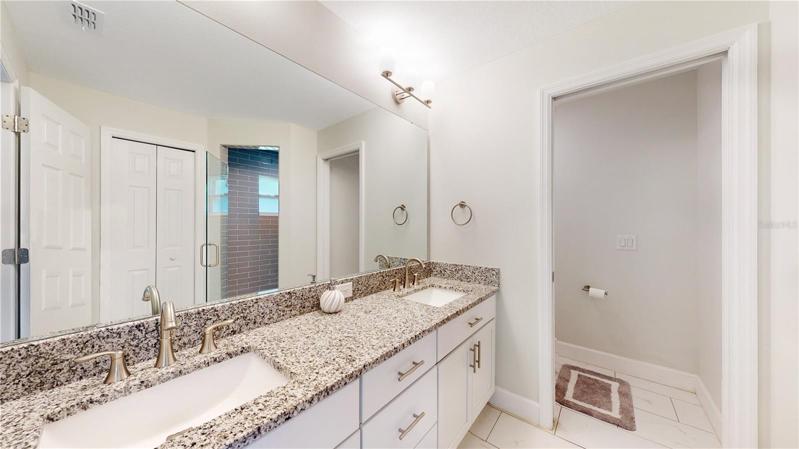Double sink primary en suite  bathroom. Granite. Mirror goes forever ....