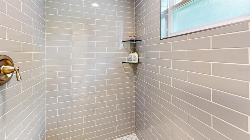 Glass tile shower in Master bathroom. Tile goes to the ceiling 