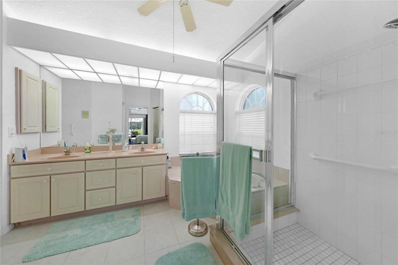Long vanity, jetted tub, double sinks and large walk-in shower highlight this bathroom.