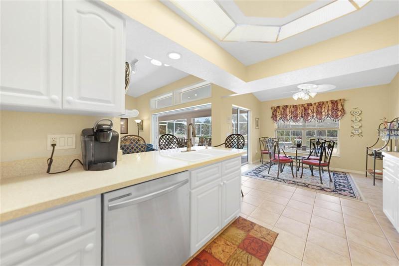 Kitchen with Breakfast Nook and multiple sliders to access Lanai and Pool.