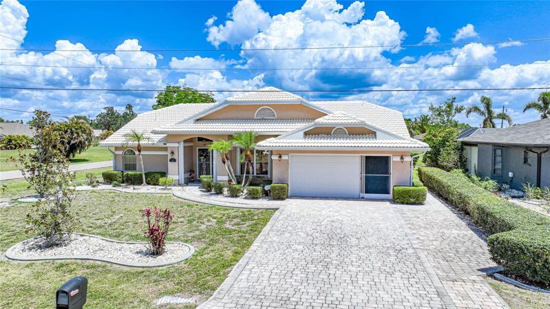 An oversized garage provides ample parking for two cars.