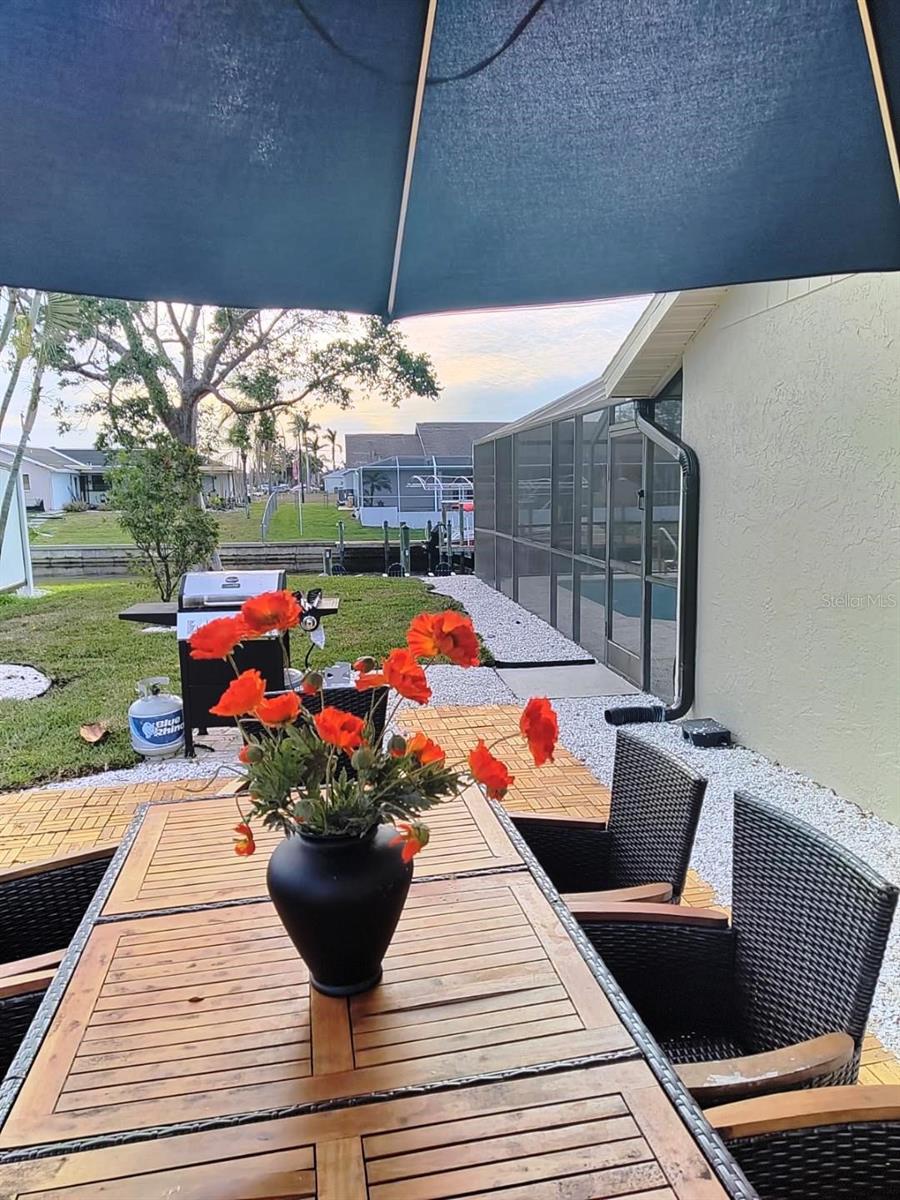 New side terrace for al-fresco dining. Seats 8 people and ovrlooks the pool and canal activity.