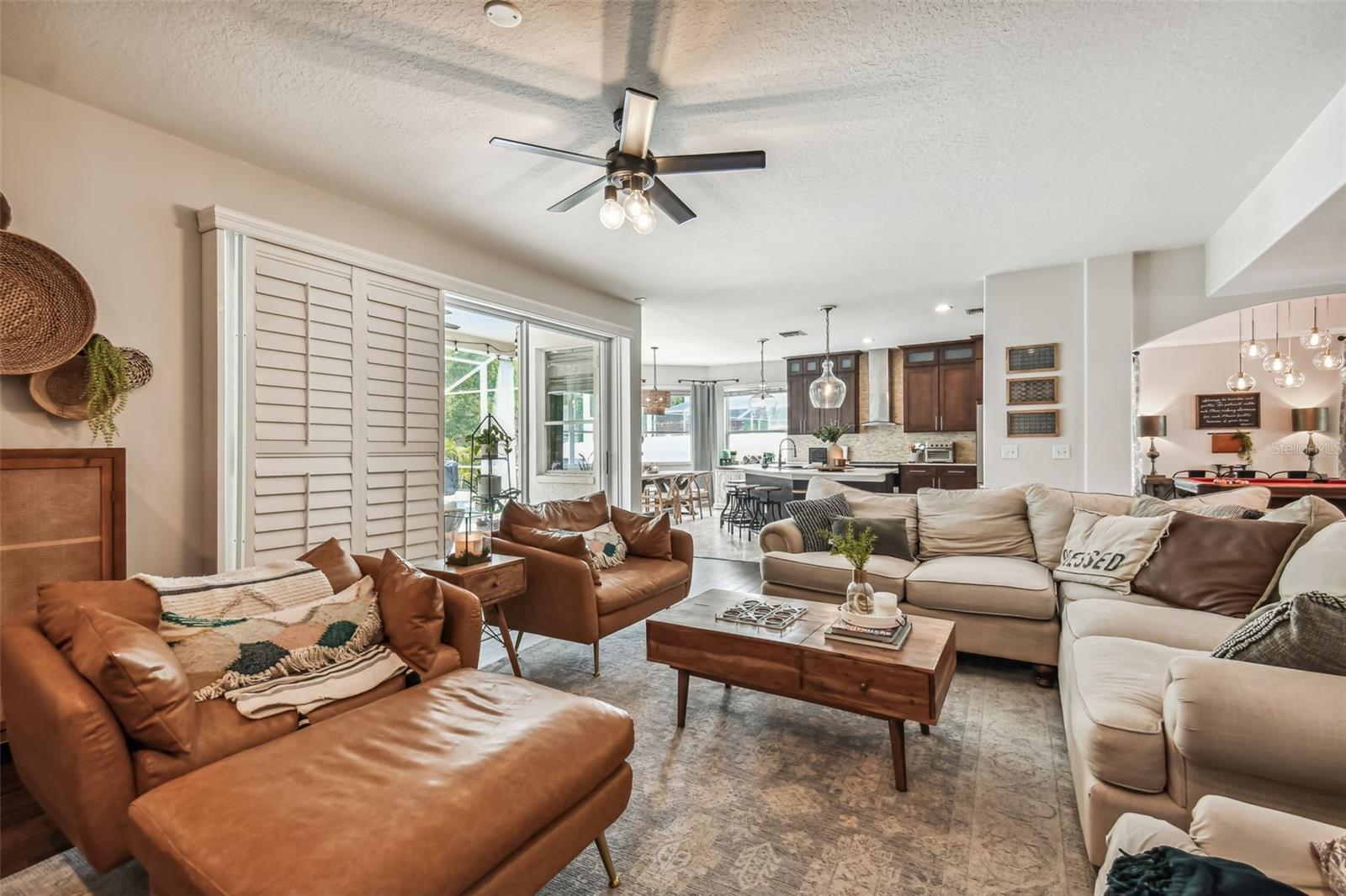 Family Room with sliding glass doors for indoor/outdoor living and plantation shutters