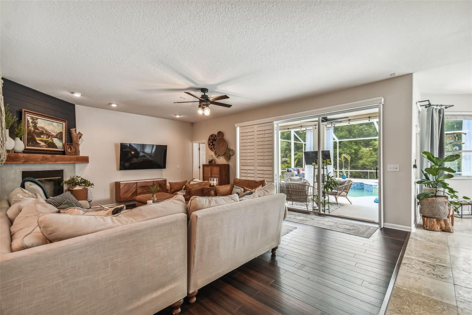 Family Room with sliding glass doors for indoor/outdoor living and plantation shutters