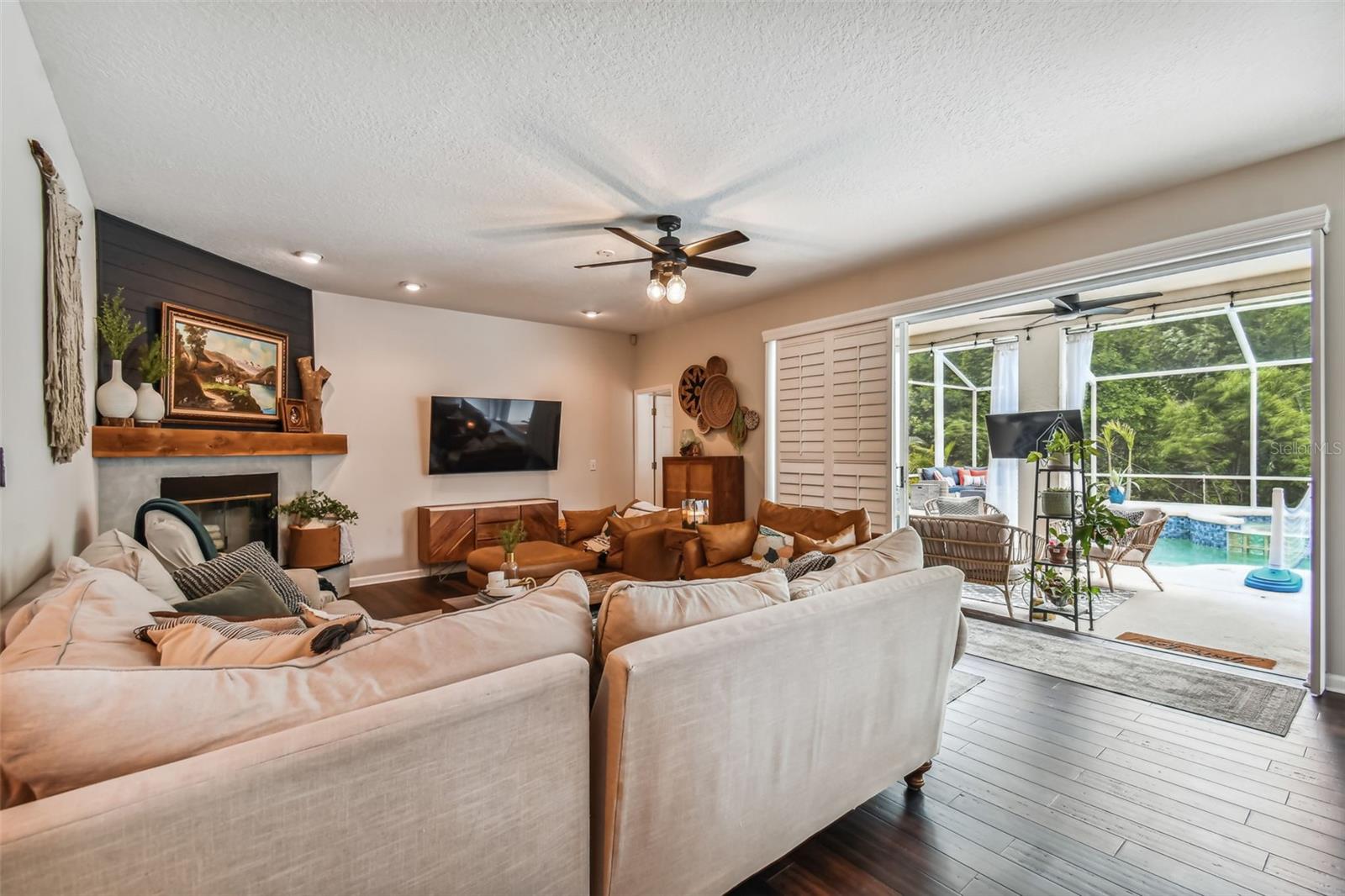Family Room with sliding glass doors for indoor/outdoor living and plantation shutters