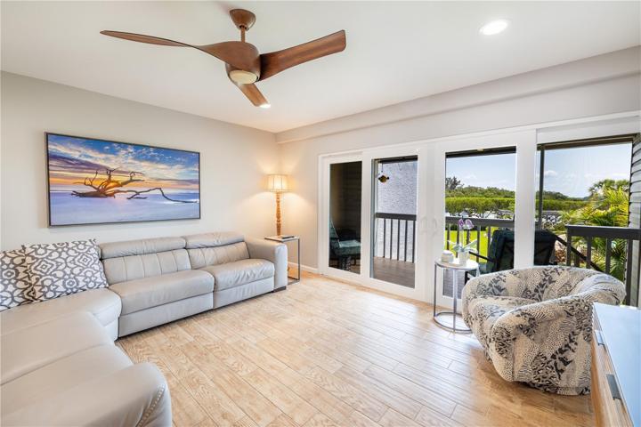 Living room has hurricane sliding doors to the private balcony